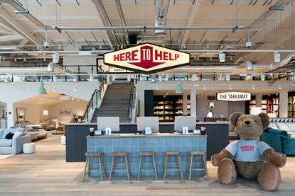 Interior of Edinburgh Loaf store featuring a huge teddy bear and counter saying 'Here to help'