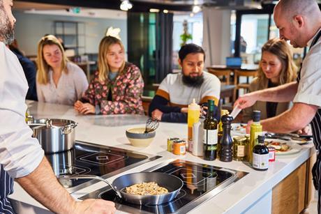 Customers watching a cooking demonstration at Kitchen facilities at Fortnum & Mason Food & Drink Studio