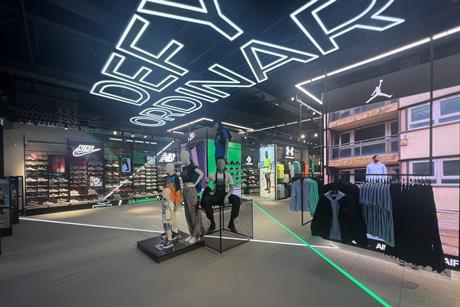 Interior of Footasylum store, Lakeside Shopping Centre, showing product on display and the words 'Defy ordinary' on the ceiling