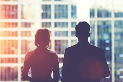 Two CEOs looking out office window