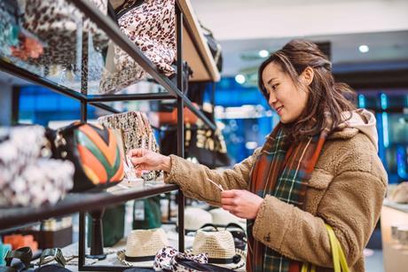 Female shopper looking at handbag in store