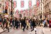 Tourists and shoppers crossing busy Regents Street