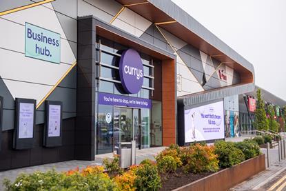 Exterior of Currys store with sign saying 'Business hub'