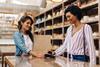 Woman paying at checkout with smartphone digital wallet