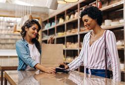 Woman paying at checkout with smartphone digital wallet