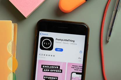 PrettyLittleThing app on a phone on a desk