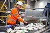 Man sorting recycling at plant