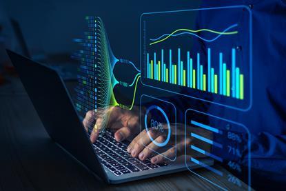 Person typing at a computer with graphics showing charts and stats