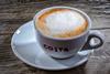 Costa coffee in a branded mug on a table