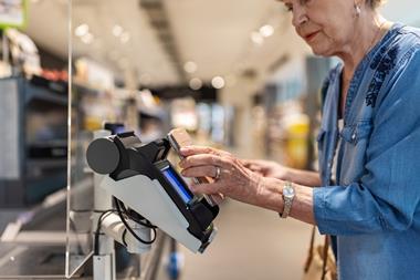 Woman paying for shopping using mobile