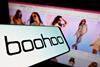 Boohoo logo on a phone with Boohoo website in background