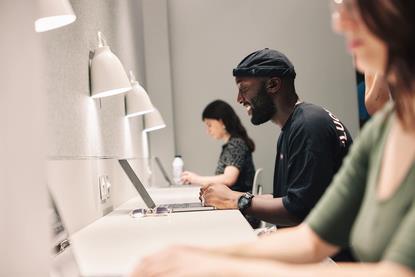 A group of people using laptops