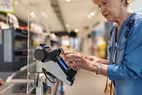 Woman paying for shopping using mobile