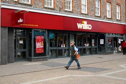 Wilko store on high street with man walking past