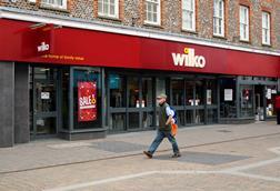 Wilko store on high street with man walking past